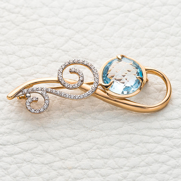 Брошь из красного золота с топазом sky и 51 фианитами