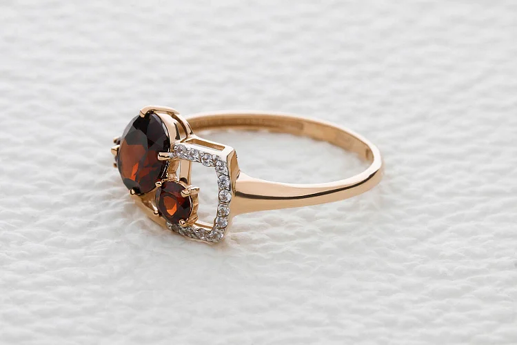 Кольцо из красного золота с 3 гранатами и 18 фианитами