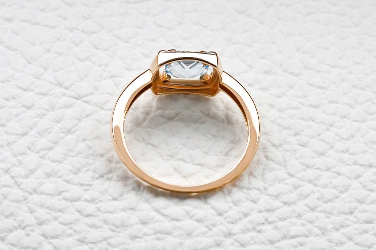 Кольцо из красного золота с топазом sky и 16 фианитами