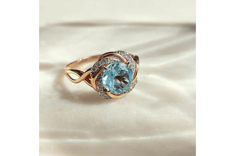 Кольцо из красного золота с топазом sky и 16 фианитами